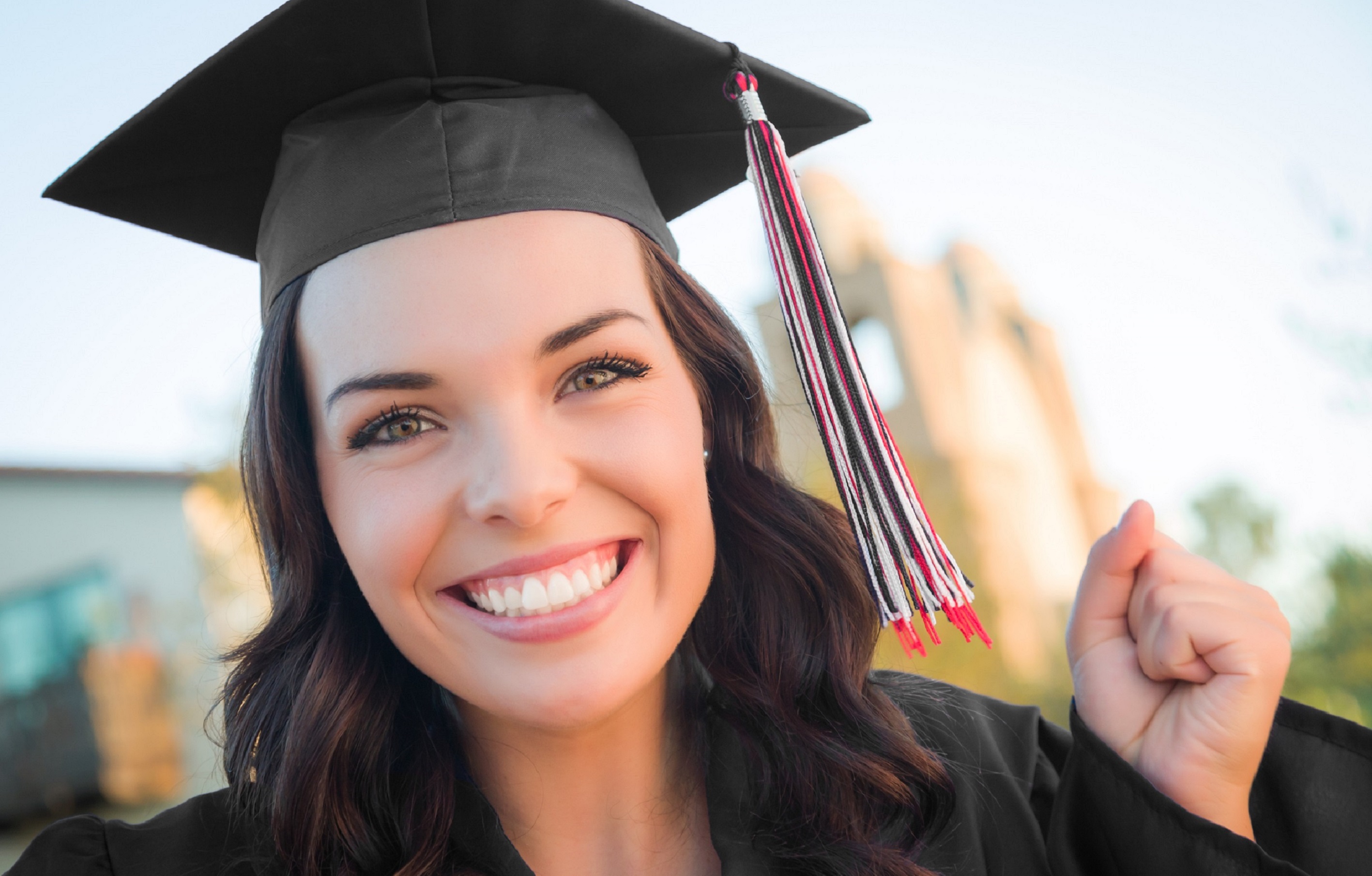 Excited Graduating Mixed Race Woman In Cap and Gown